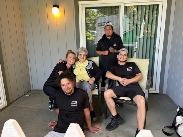Friendly Betsy’s Moving crew helping a senior woman with her move